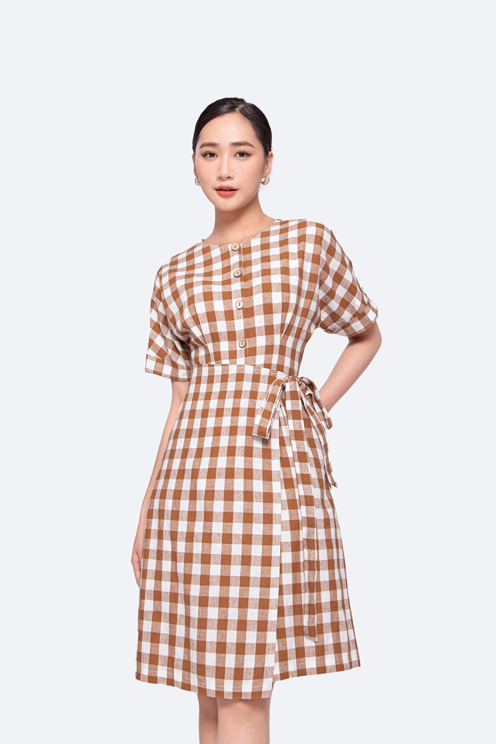 Đầm chữ a họa tiết caro phối nơ eo tùng đắp chéo