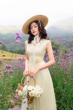 Đầm tơ xòe màu kem cổ V đính hoa eo