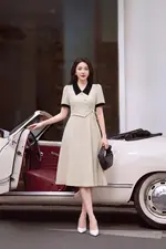 Đầm xòe màu kem phối đen nhấn nơ eo